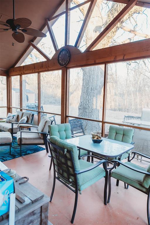 6078 East Line Road Whitewright, TX 75491 - Photo 31 of 32 Sunroom with a skylight, high vaulted ceiling, and concrete flooring