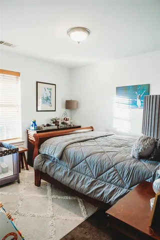 a bedroom with a bed and window