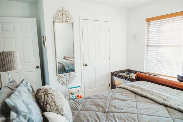 a bedroom with a bed and a window