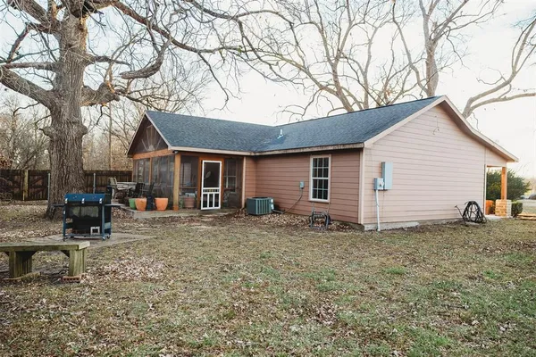 a backyard of a house with yard and outdoor seating