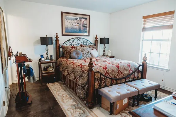 a bedroom with bed and a window