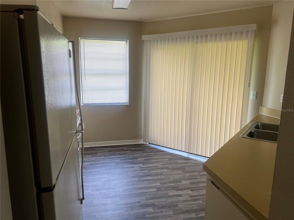 7266 Pond Circle Spring Hill, FL 34606 - Photo 5 of 11 an empty room with wooden floor and windows