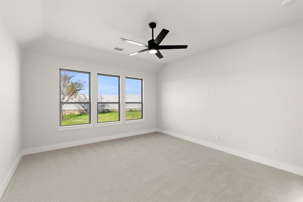 2917 Andesite Road McKinney, TX 75071 - Photo 14 of 27 an empty room with windows and fan