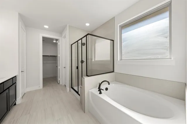a bathroom with a bathtub and a shower