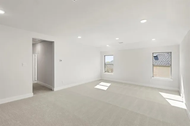 an empty room with windows and closet