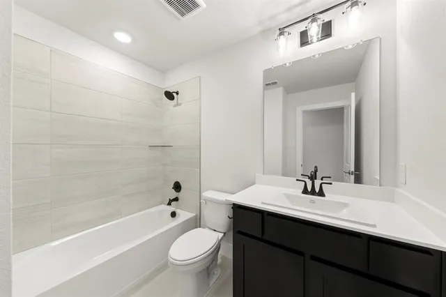 a bathroom with a sink a toilet and bathtub