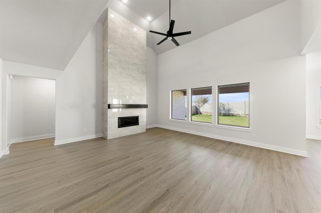 2917 Andesite Road McKinney, TX 75071 - Photo 4 of 27 a view of an empty room with a window and wooden floor