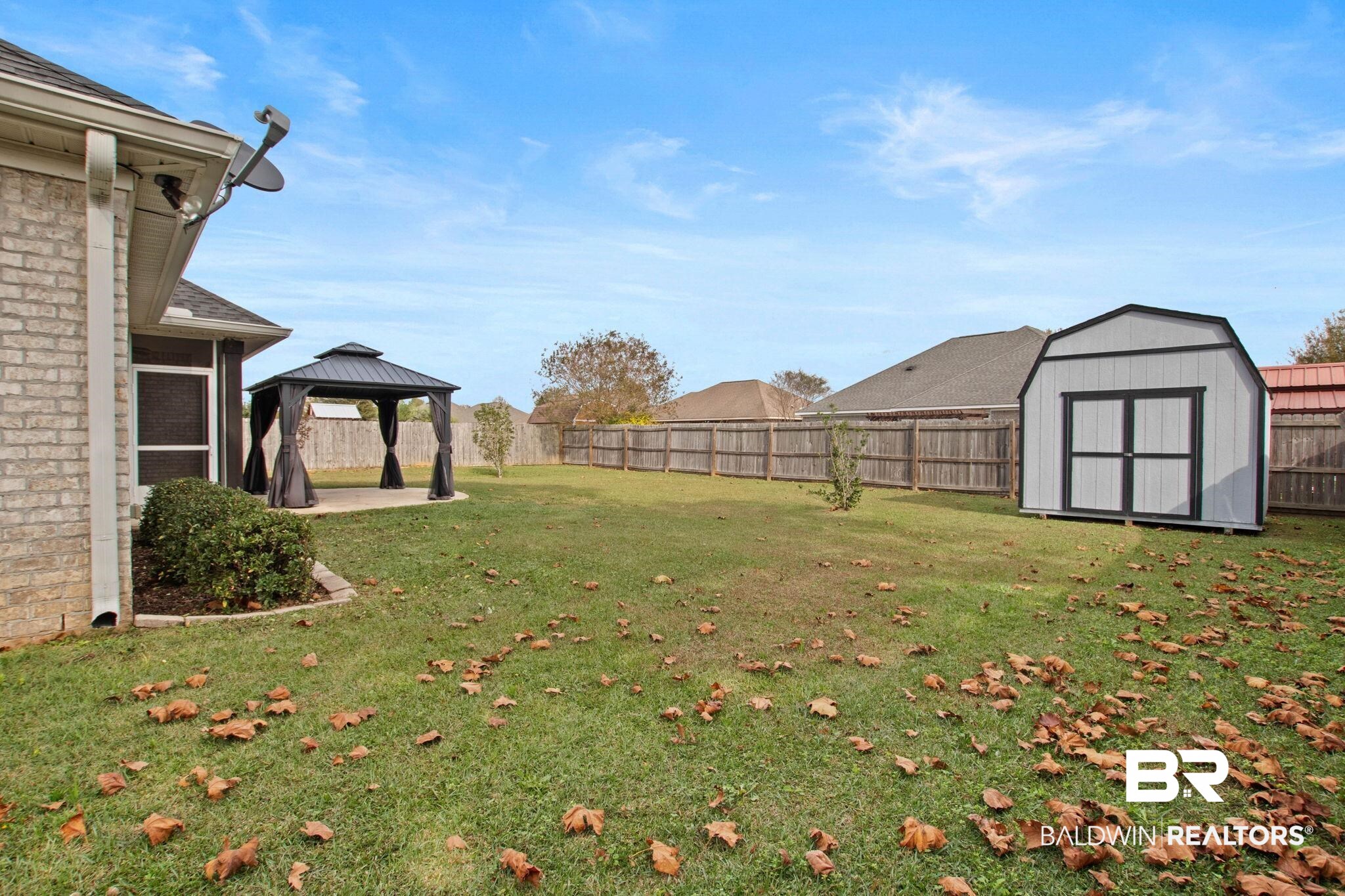 17376 Bankhead Boulevard Fairhope, AL 36532 - Photo 61 of 73 Fenced backyard with a patio, a storage unit, and a gazebo
