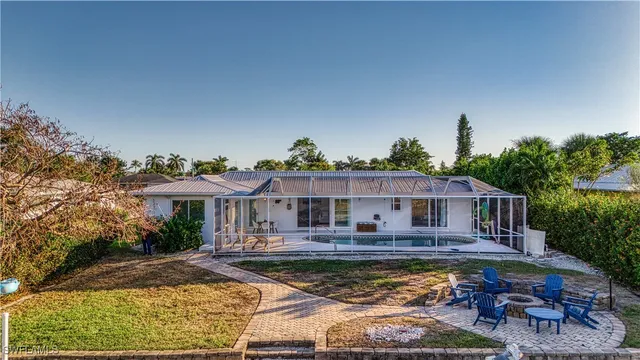 a view of a house with swimming pool and sitting area