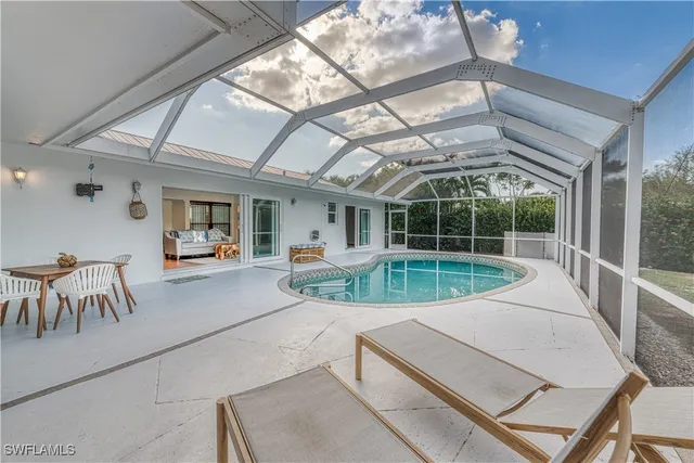 a view of a patio with a table and chairs