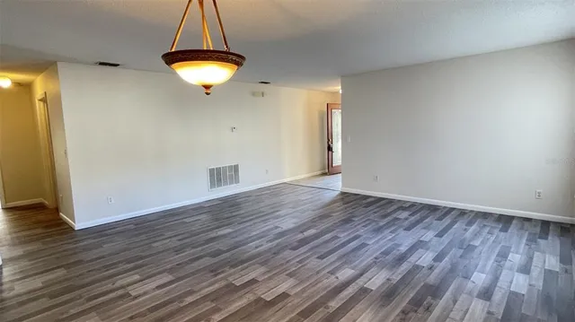 a view of room with wooden floor and window