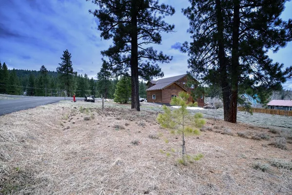 a view of a dirt road with a building in the background