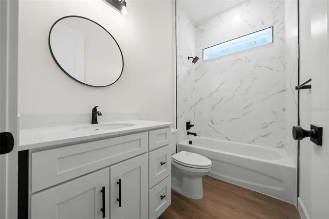 a bathroom with a sink a toilet and a mirror