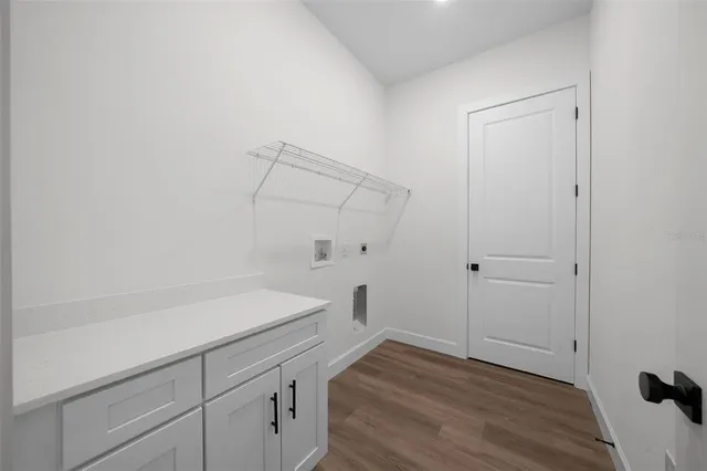 a view of a room with wooden floor