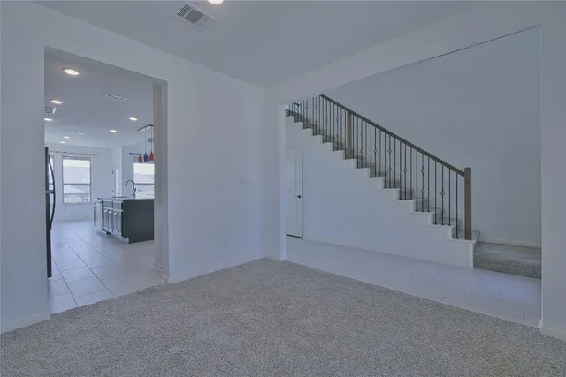 a view of a kitchen with a sink and a refrigerator
