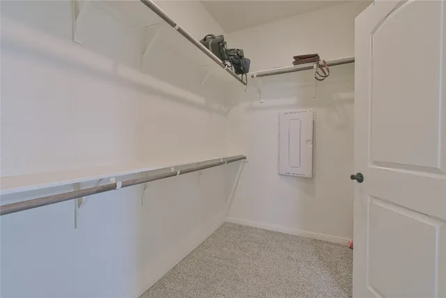 a spacious bathroom with a granite countertop sink a toilet and mirror
