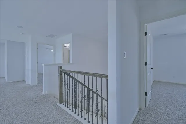 an empty room with chandelier fan