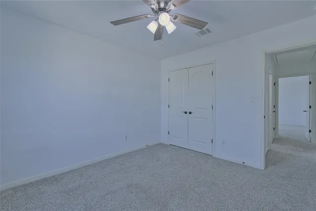 a bathroom with a granite countertop sink a toilet and a mirror