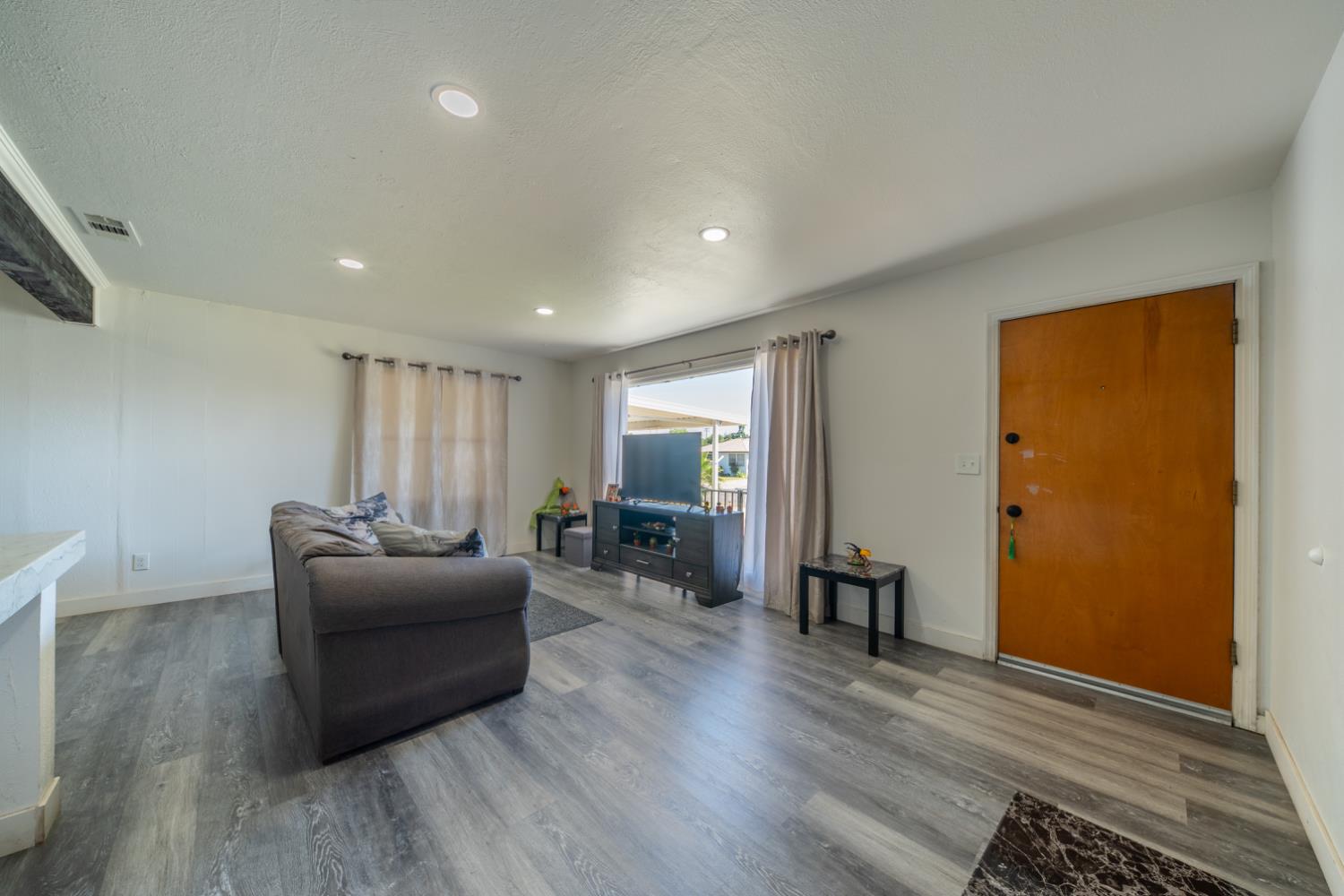 1004 West Pontiac Way Fresno, CA 93705 - Photo 11 of 34 a living room with furniture and a wooden floor
