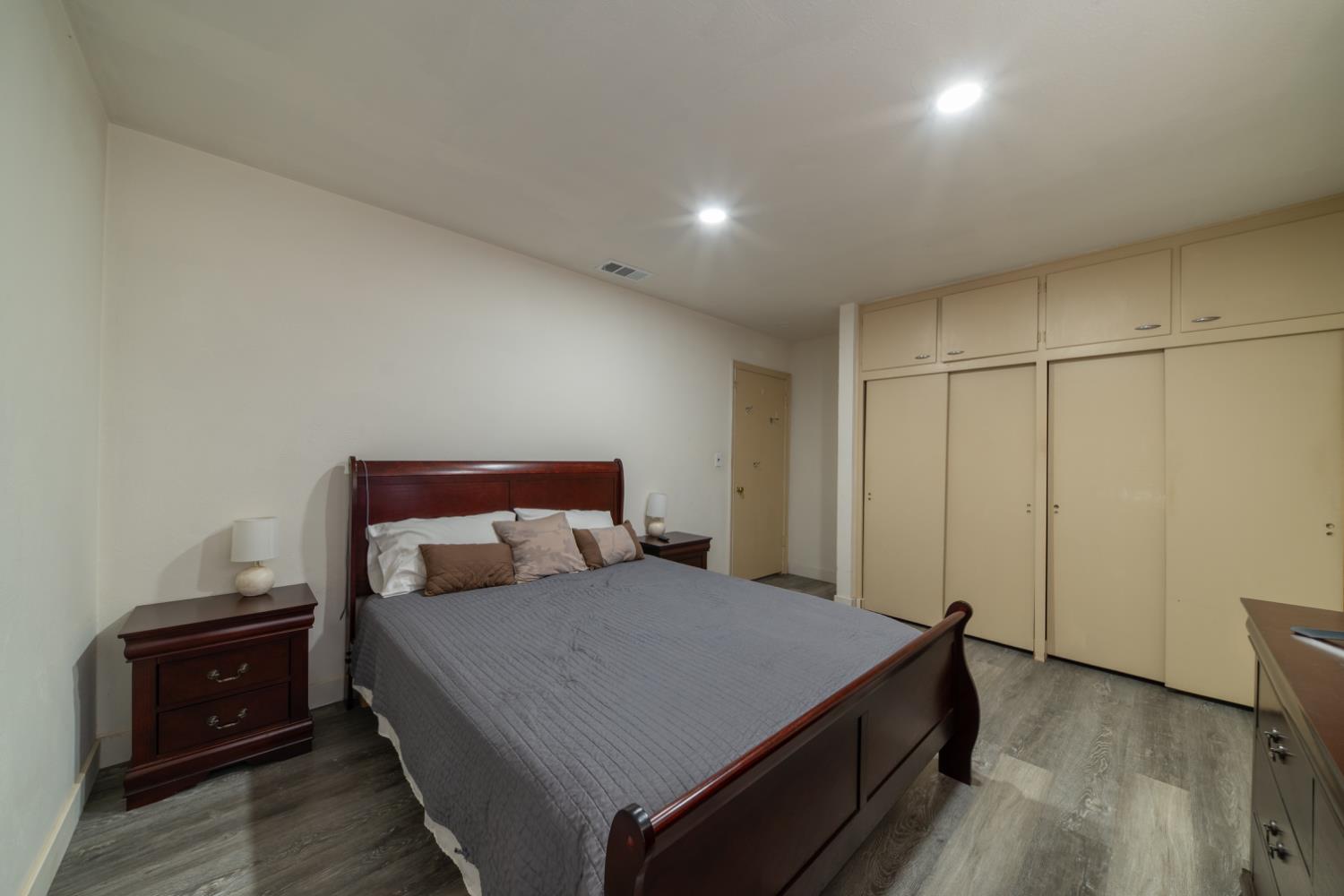 1004 West Pontiac Way Fresno, CA 93705 - Photo 14 of 34 a bedroom with a bed and wooden floor
