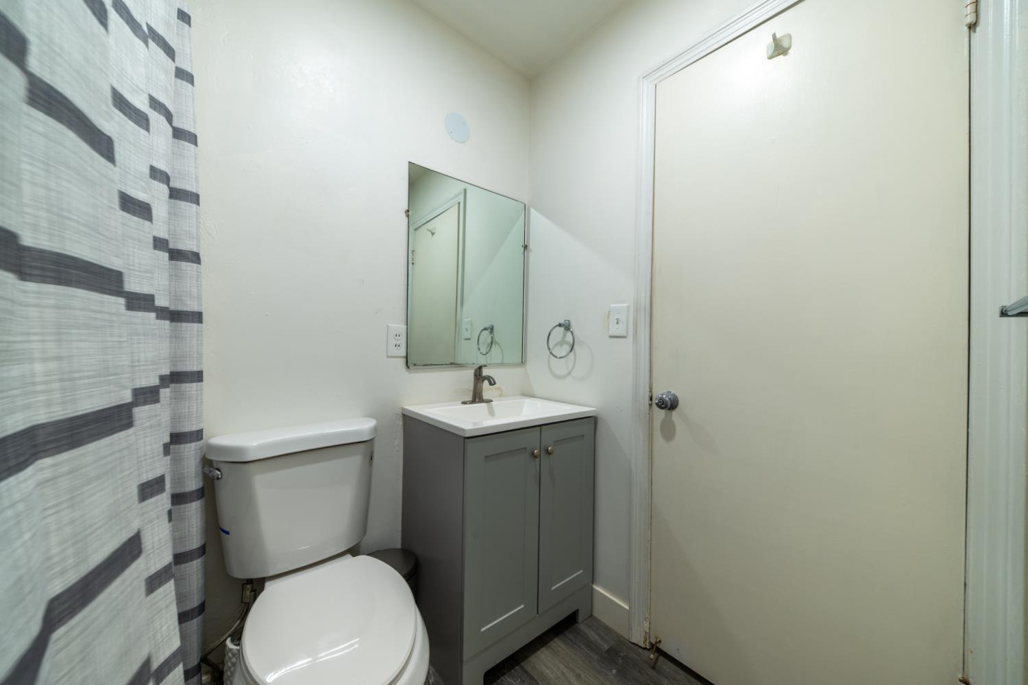 1004 West Pontiac Way Fresno, CA 93705 - Photo 24 of 34 a bathroom with a toilet sink and mirror
