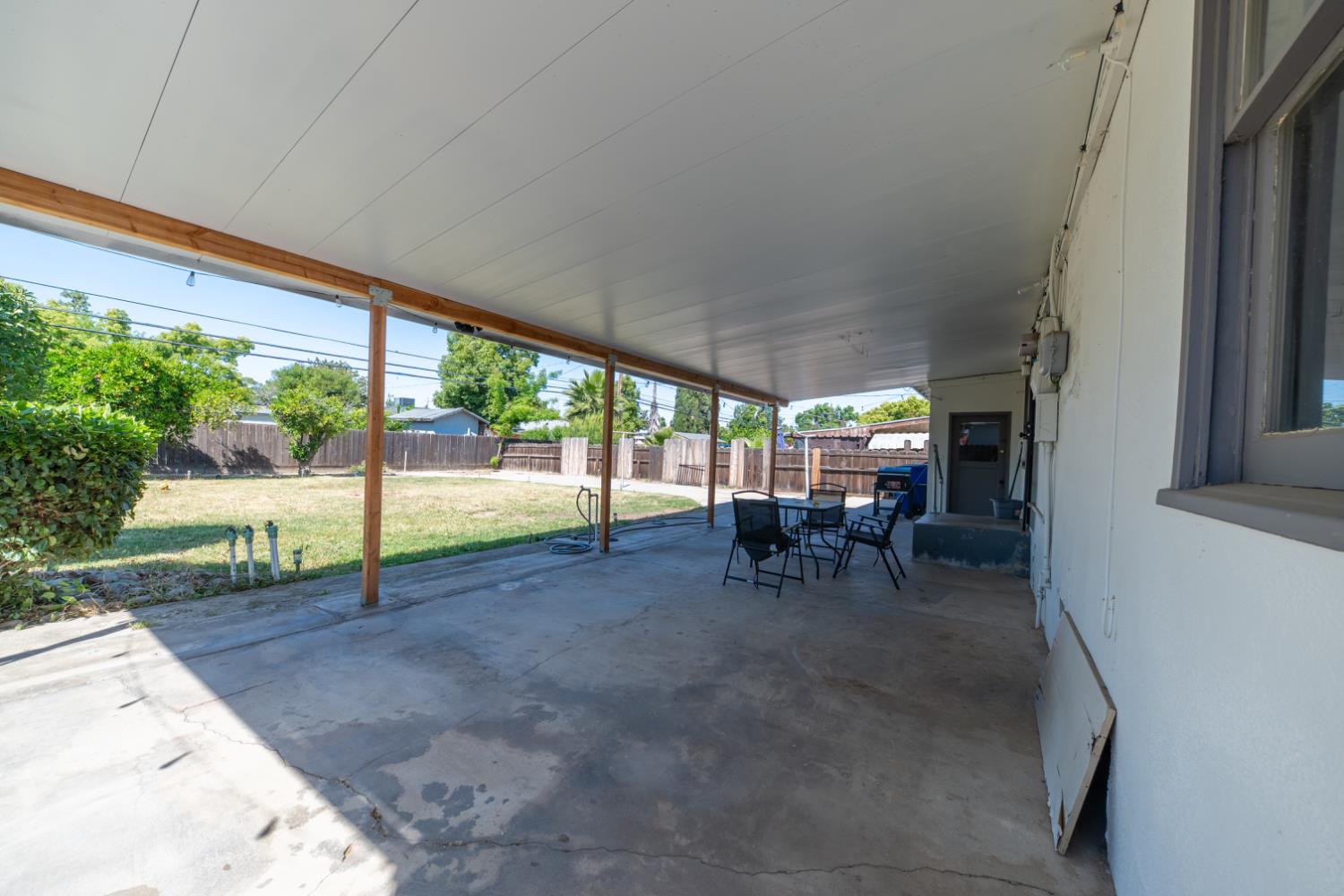1004 West Pontiac Way Fresno, CA 93705 - Photo 27 of 34 a view of a porch with chairs and backyard