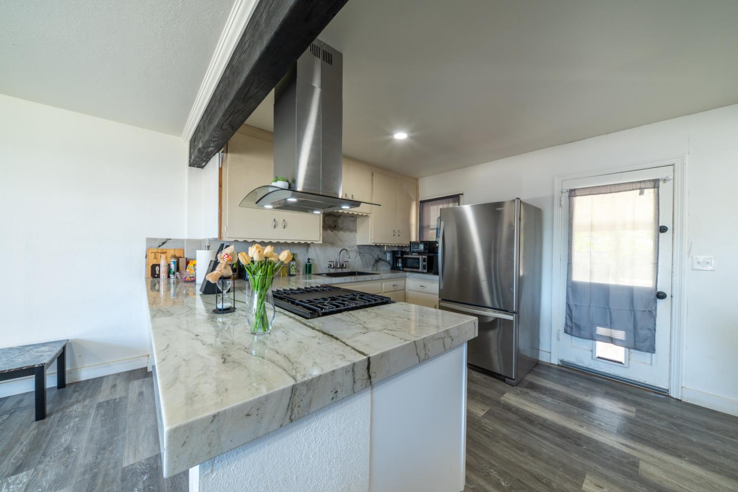 1004 West Pontiac Way Fresno, CA 93705 - Photo 5 of 34 a kitchen with stainless steel appliances granite countertop a sink a stove and a refrigerator