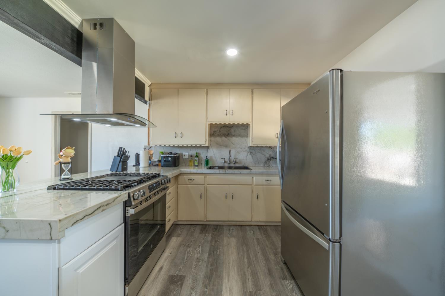 1004 West Pontiac Way Fresno, CA 93705 - Photo 6 of 34 a kitchen with stainless steel appliances granite countertop a stove a refrigerator and a sink