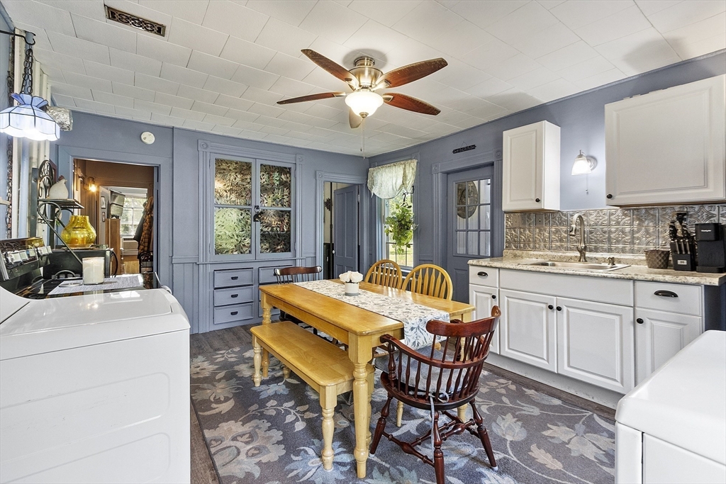 171 South Road Templeton, MA 01436 - Photo 15 of 38 a kitchen with a dining table chairs and white cabinets