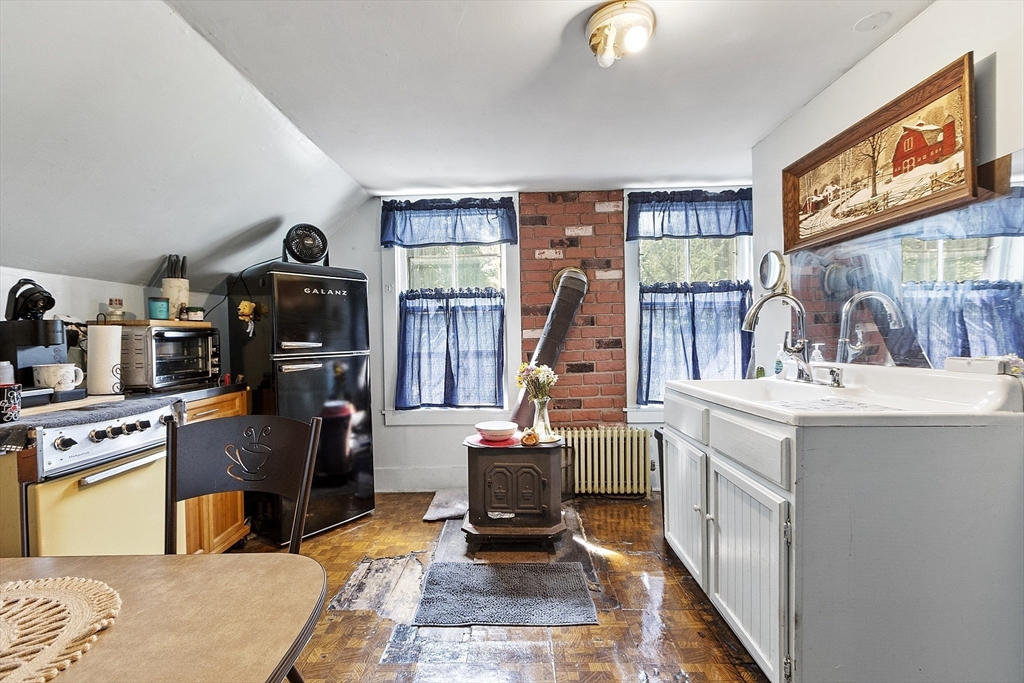 171 South Road Templeton, MA 01436 - Photo 29 of 38 a living room with furniture a flat screen tv and a floor to ceiling window
