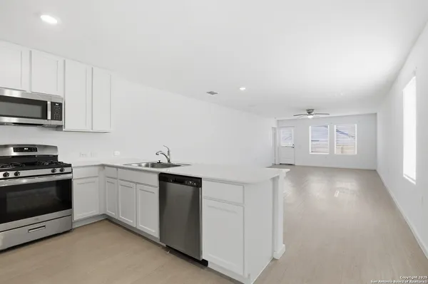 a kitchen with stainless steel appliances granite countertop a stove and a sink