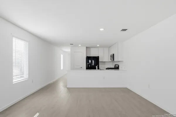 a view of a kitchen with a sink and a window
