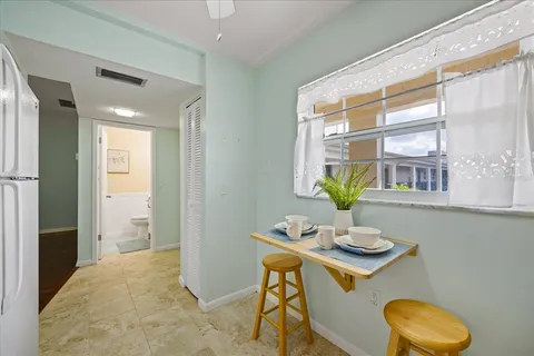 a dining room with a table and chairs