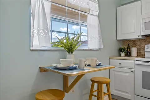 a kitchen with a sink a stove and a window