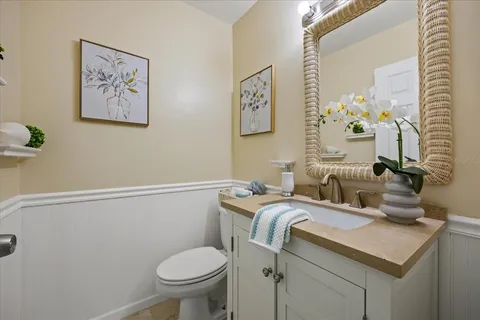a bathroom with a granite countertop sink a toilet and a mirror