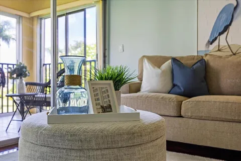 a living room with furniture and floor to ceiling windows