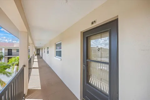 a hallway with wooden floor and stairs