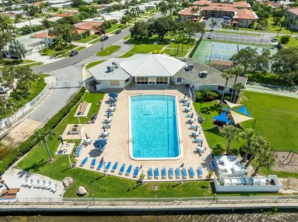 an aerial view of a house with a garden and swimming pool
