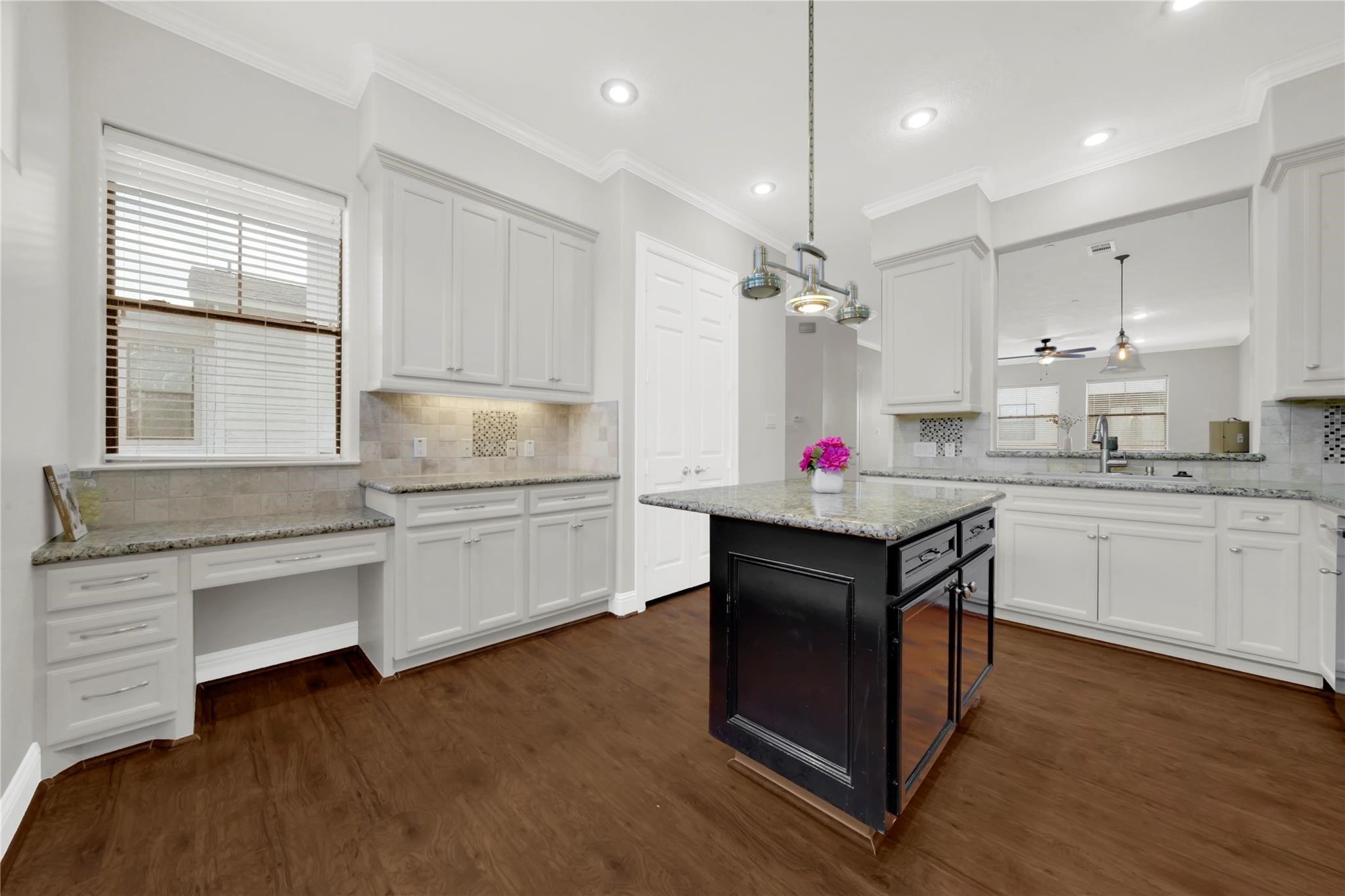 2609 Riverside Drive, Unit C Houston, TX 77004 - Photo 12 of 32 a kitchen with granite countertop a sink cabinets and wooden floor