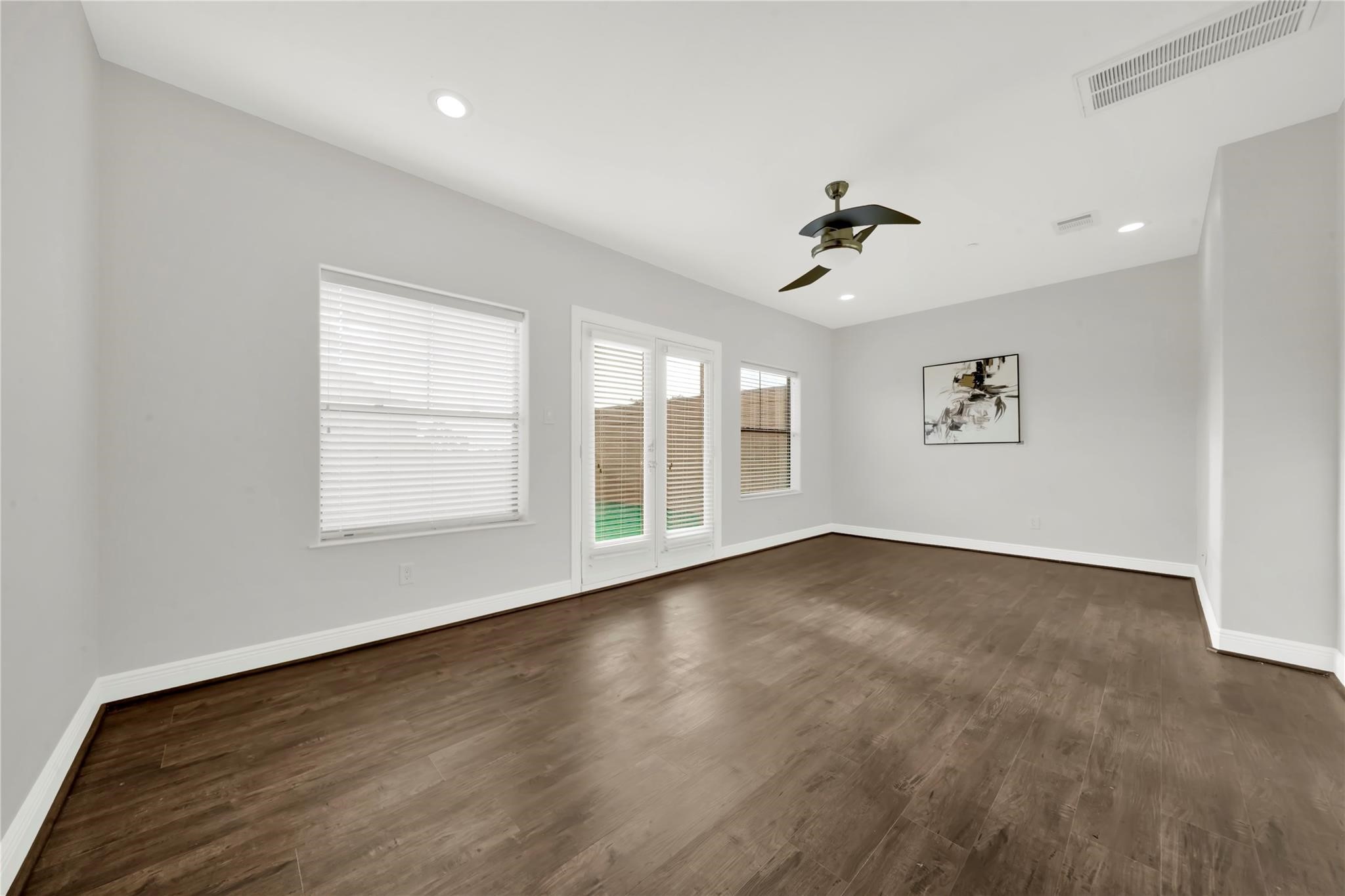 2609 Riverside Drive, Unit C Houston, TX 77004 - Photo 27 of 32 an empty room with windows and ceiling fan