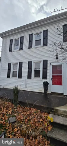 a view of a backyard with table and chairs with wooden fence