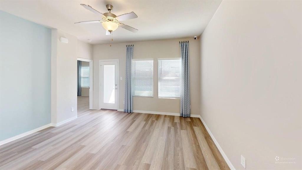 1168 Yucca Avenue Lavon, TX 75166 - Photo 11 of 27 a view of an empty room with window and wooden floor
