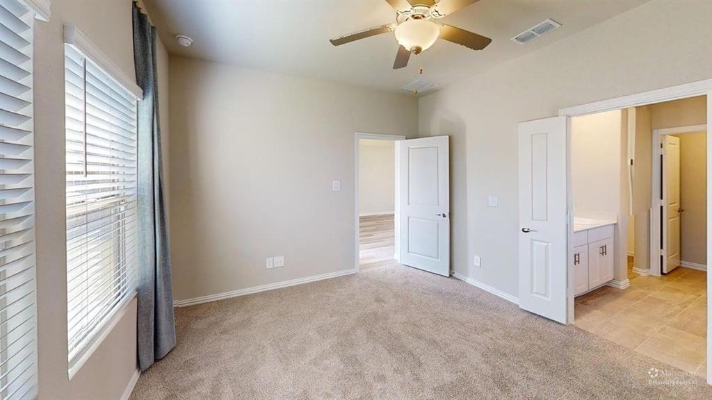 1168 Yucca Avenue Lavon, TX 75166 - Photo 12 of 27 an empty room with chandelier fan and windows