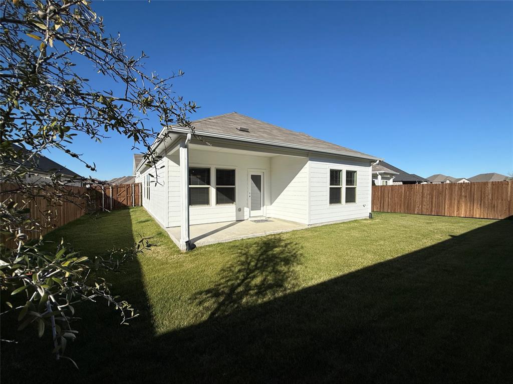 1168 Yucca Avenue Lavon, TX 75166 - Photo 25 of 27 a white house with green field in front of it