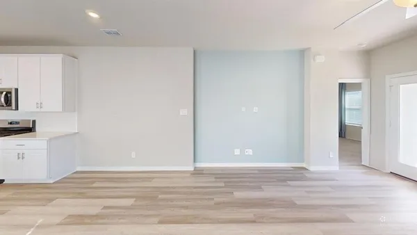 a view of a kitchen with wooden floor