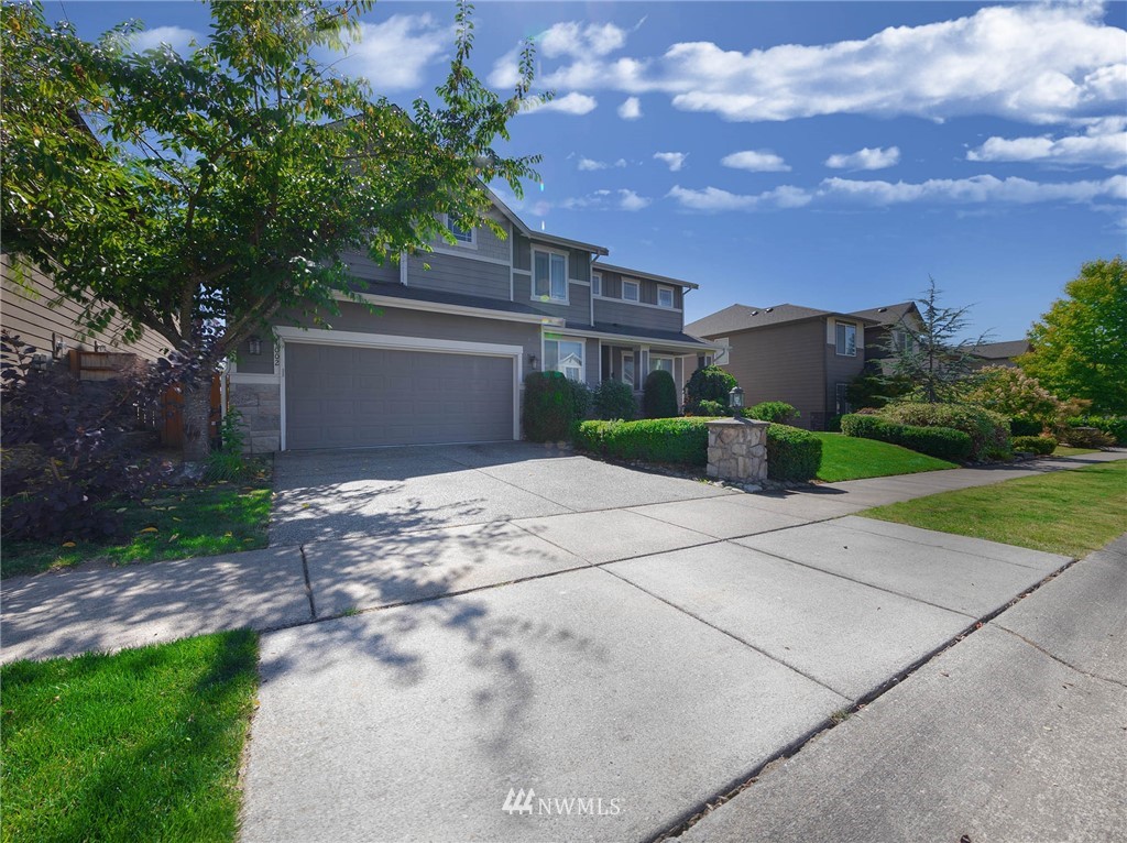 4002 216th Place Southeast Bothell, WA 98021 - Photo 2 of 28 a front view of a house with a yard and a garage