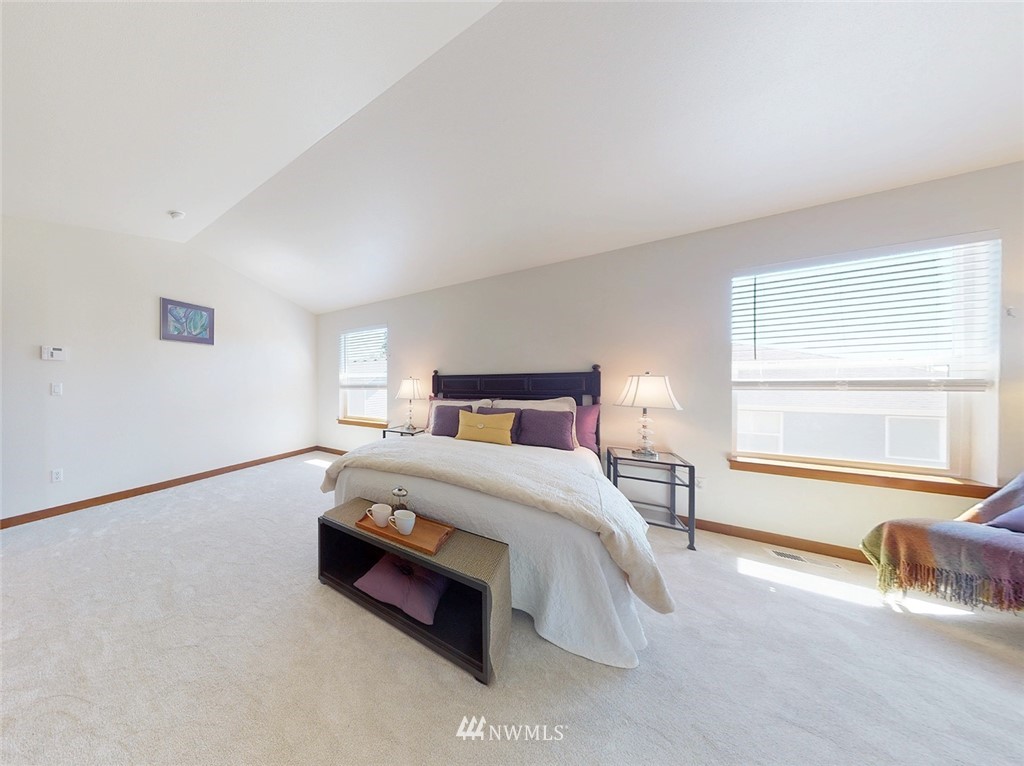 4002 216th Place Southeast Bothell, WA 98021 - Photo 17 of 28 a spacious bedroom with a bed and a large window