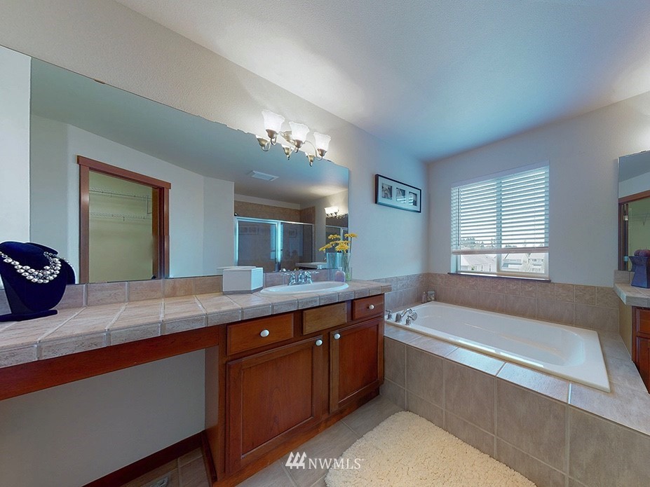 4002 216th Place Southeast Bothell, WA 98021 - Photo 20 of 28 a spacious bathroom with a granite countertop tub a double vanity sink and a window