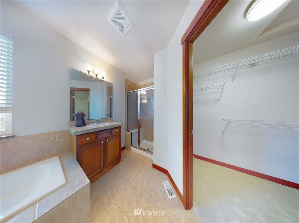 4002 216th Place Southeast Bothell, WA 98021 - Photo 21 of 28 a spacious bathroom with a double vanity sink and a mirror