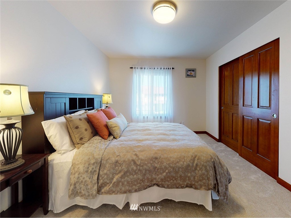 4002 216th Place Southeast Bothell, WA 98021 - Photo 22 of 28 a bedroom with a bed and wooden floor